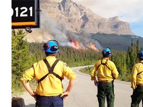 Parks Canada fire specialists assess the Spreading Creek wildfire in Banff National Park.