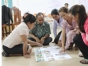 Participants place flash cards in order of improved sanitation conditions at a latrine-building workshop in Kampong Thom, Cambodia.