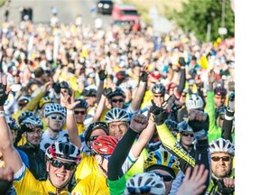 Participants in the Ride to Conquer Cancer offer an encouraging wave at the opening ceremonies of the two-day event. The sixth annual event attracted numerous cyclists and volunteers and raised $7.9 million for the Alberta Cancer Foundation. (Photo courtesy Sombilon Photography)