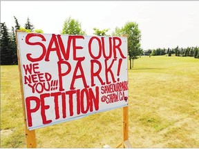 A petition sign stands in Scenic Acres Park, where a francophone school is to be built. Reader says the school is not a good fit for the site.