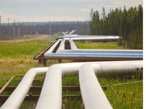 Pipelines carrying steam, gas and an emulsion of bitumen and water snake through the boreal forest near Conklin, Alta., 120 kilometres south of Fort McMurray, Alta. File photo.