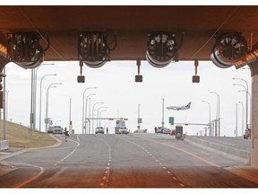 A plane coming in for landing on the old runway could be seen during a sneak peek at the new airport tunnel on May 21. (Colleen De Neve/Calgary Herald)