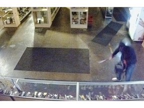 Police are asking for the public’s assistance to find a man who broke into The Shooting Edge on May 11. Surveillance footage shows the man smashing a baseball bat into a display case, and removing 11 handguns. (Calgary Police/Calgary Herald)