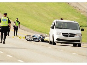 Police investigate the scene of a fatal collision between a motorcycle and deer on Macleod Trail at 210th Ave. S.E. on May 23, 2013.