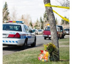 A police car stands watch over the home where Sanjula Devi and Fahmida Velji-Visram were fatally stabbed on Wednesday May 7, 2014.