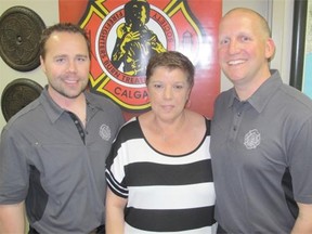 Posing at the Calgary Firefighters Burn Treatment Society’s annual Firefighters Ladies Night at the Italian Club are society secretary Jason Matthews, left, Italian Club executive director Rafela Grossi, and society president Ray Musulak.