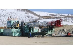 A Precision Drilling crew prepares a super single rig to move. It is selling U.S. rig-moving equipment to Aveda Transportation of Calgary.