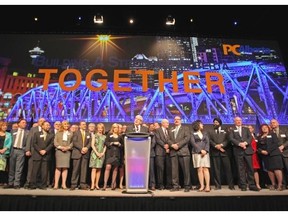 Premier Dave Hancock, centre, was joined by his caucus as he spoke to a crowd of 1,800 Progressive Conservative supporters at the Telus Convention Centre during the annual party Leaders Dinner on Thursday.