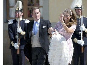 Princess Madeleine of Sweden (R) and her husband Christopher O’Neill hold their daughter, Princess Leonore on June 8, 2014 after her christening at the Royal Chapel in Drottningholms royal palace near Stockholm.