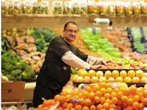 Produce manager Prenesh Singh puts fruit on the shelves of the new Co-op store that is replacing the Safeway store in Mill Woods Town Centre on Wednesday, May 7, 2014.
