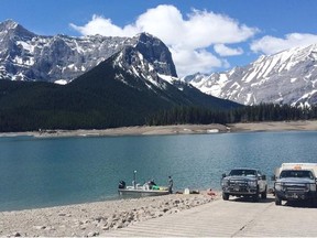 An RCMP dive team searches the Upper Kananaskis Lake on Tuesday for a kayaker who went missing Sunday. A body was recovered Tuesday afternoon. (RCMP)
