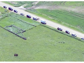 RCMP members continue their search for evidence in the disappearance of five-year-old Nathan O’Brien and his grandparents, Alvin and Kathy Liknes, in a field northeast of Airdrie on Monday.