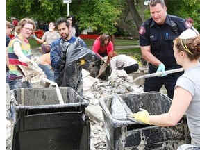 Residents and volunteers clean up in Erlton after the June 2013 floods. Businesses in Calgary lost hundreds of millions due to flooding but many stepped up to help make a difference in the recovery.
