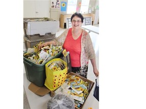 Reverend Susan Lukey with sunflower seeds that will be mailed out to High River residents. The sunflowers are a symbol of hope and compassion, and 18,000 seeds have been received from across Canada.