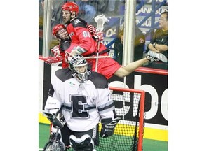 Peter McFetridge of the Calgary Roughnecks, 80, celebrates his first quarter goal on Edmonton Rush goalie Aaron Bold with teammate Cory Conway.