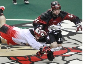 Roughnecks faceoff ace Geoff Snider, left, got tangled up with his brother, Mammoth defender Bob Snider, during the NLL playoff opener for Calgary and hasn’t played since due to injury. He hopes to return Saturday in the Champion’s Cup finale.