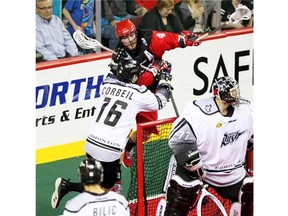 Roughnecks transition star Geoff Snider gets some air trying to tuck the ball behind Rush goalie Aaron Bold while defender Chris Corbeil gives him a shove in a meeting earlier this season. Snider will sit out Game 1 of the West Division final.