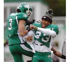 Roughriders defensive back Macho Harris, right, celebrates his interception with then-teammate Dwight Anderson during the pre-season. Anderson has since been traded to the Toronto Argonauts and faces the Stampeders on Saturday.