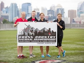 SAIT Trojans cross-country running coach Jamie Grant, left, and runners Sean Hickey, Lucianna Dykstra and Rebecca Gould hold up the CCAA cross-country running nationals logo at SAIT on Wednesday.