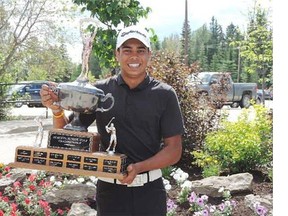 Nic Scrymgeour celebrates with the 2013 Alberta junior boys championship trophy.
