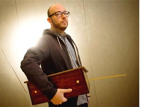 Sean Michaels, author of Us Conductors, poses with his theremin. His father made it secretly as a gift.