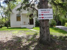 A sign still hangs on a tree in Bowness one year after the floods of June 2013 in Calgary.