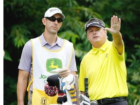 Paul Goydos talks to his caddie during the PGA Tour's John Deere Classic last month. Four years earlier, in the same tournament, he shot a 59.
