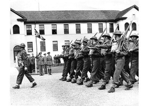Soldiers march past officers on the parade square of Currie Barracks during the Second World War.