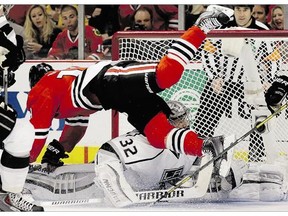 Chicago Blackhawks Jonathan Toews flies over Los Angeles Kings goalie Jonathan Quick during the second period in Game 1 of the Western Conference finals in Chicago on Sunday.