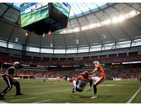 Calgary Stampeders' Fred Bennett (8) intercepts a pass intended for B.C. Lions' Whitman Tomusiak (89) during the second half of a pre-season CFL football game in Vancouver, B.C., on Friday June 20, 2014.