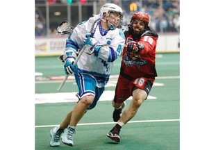 The Knighthawks’ Cody Jamieson and Roughnecks defensman Mike Carnegie tangle during the first half of the Calgary Roughnecks vs Rochester Knighthawks Champion’s Cup game 2 in Rochester on Saturday night.