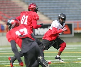 Stampeders defensive back Jamar Wall, left, gets out behind slotback Jabari Arthur and wide receiver Maurice Price, during Friday’s practice at McMahon Stadium. Wall leads the Stamps with four interceptions this season.