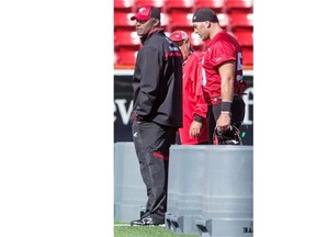 Stampeders guest coach Robert McCune, left, views practice along with long snapper Randy Chevrier. Despite being three years younger than Chevrier, McCune is transitioning to the next phase of his football career.