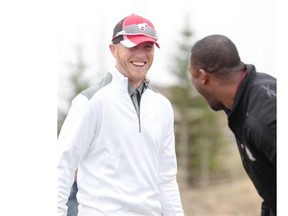 Stampeders quarterback Bo Levi Mitchell, left, and teammate Charleston Hughes share a laugh while taking part in the Henry Burris Celebrity Golf Tournament at Springbank Links Golf Course on Friday. Mitchell will come to Stamps training camp ready to compete for the starting job.