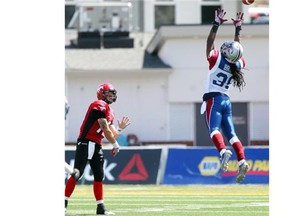 Stamps quarterback Bo Levi Mitchell throws just above the giant leap of Montreal’s Jerald Brown during their season opener on June 28. Calgary hasn’t played since and is set to get back into action against Toronto this Saturday.