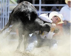 Steer wrestler Morgan Grant held tight in a time of 4.4 seconds during the Stampede rodeo Wednesday. Reader says rodeo should come to an end.