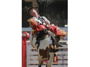 Wes Stevenson of Lubbock, Tx goes for a ride on Up Ur Alley and earned an 87 at the Calgary Stampede Rodeo on Monday.