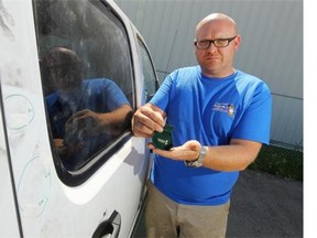 Wes Coxe holds a small satchel used to contain ashes next to his truck in Calgary, Alberta Monday, August 11, 2014. Coxe says a satchel, of the same make and design, containing the remains of his baby daughter, was stolen from his truck Sunday night. He and police are asking for assistance in its recovery.