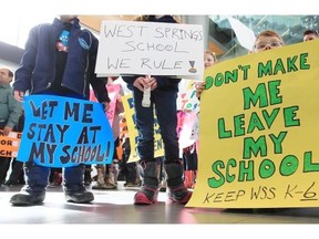 Students of West Spring School hold protest signs at Calgary Board of Education headquarters in March.