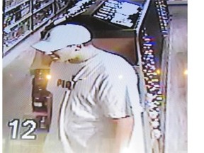 A man suspected of attempting to steal a $1,000 bottle of cognac from an Airdrie liquor store is seen in security camera footage.