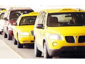 Taxis line up for passengers at Calgary International Airport. A new city report is recommending the release of 383 new taxi plates to the 1,526 currently in operation.