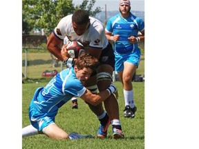BC2’s team member Taitusi Vikilani tries to escape from Quebec’s Michael Nodafferi during the final of the U18 during the Rugby National Festival, in Calgary on August 10. B.C. won the game 35-10 as the western province swept the U18 divisions (also winning the women’s final 10-7 over Ontario).