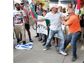 Tempers flared between pro-Palestinian and pro-Israeli protesters who took to the steps of Calgary City Hall on July 18. A number of skirmishes broke out between the two factions as the group was protesting Israel’s bombing of Gaza.