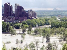 THEN: The swollen Bow River was photographed from Centre Street North after it flowed over its banks and submerged Prince’s Island Park on June 21, 2013.