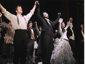 This May 12, 2014 photo released by The Publicity Office shows, front row from left, Jeremy Hays, Norm Lewis, and Sierra Boggess acknowledging applause on opening night for Lewis and Boggess after the Broadway production of "The Phantom of the Opera" at The Majestic Theatre,  in New York. Lewis is the first African-American actor to take on the title role in Broadway's ìThe Phantom of the Opera.î (AP Photo/The Publicity Office, Bruce Glikas)