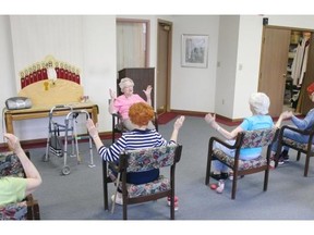 In this April 29, 2014 photo, Hildegard Gigl leads a twice weekly exercise class at Hawthorne Terrace independent retirement center in Wauwatosa, Wis. Gigl, who turns 99 in June, is the oldest one in the class. "I'm getting older but I'm not getting old," she says. (AP Photo/Carrie Antlfinger)