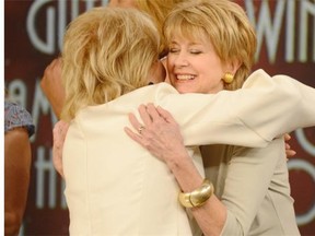 This image released by ABC shows Barbara Walters, left, embracing fellow female broadcaster Jane Pauley during a taping of Walters' final co-host appearance on "The View," Thursday, May 15, 2014 in New York. (AP Photo/ABC, Ida Mae Astute)