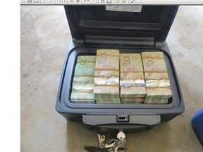 This photo, supplied Wednesday by Red Deer RCMP, shows evidence seized in a nine-month drug investigation, including 2.2 kg of marijuana and $230,000 in currency.