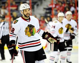 This Sept. 20, 2013, file photo shows Chicago Blackhawks left wing Brandon Bollig (52) reacting during the first period an NHL preseason hockey game against the Washington Capitals in Washington.  Bollig was traded to the Calgary Flames on Saturday, June 28, 2014, by the Blackhawks. Chicago gets the 83rd-overall selection in the 2014 Draft in return.