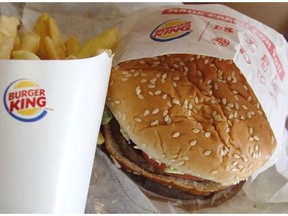 This Wednesday, June 20, 2012 file photo shows a burger and fries at a Burger King in Richardson, Texas. The Miami-based chain on Thursday, May 8, 2014 announced it is offering “Burgers for Breakfast,” which include its Whoppers, Cheeseburgers and Big King sandwiches, as well as its Original Chicken Sandwich, french fries and apple pie. (AP Photo/LM Otero, File)